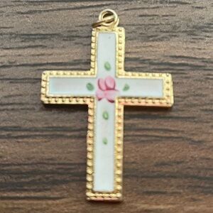 Gold trim cross pendant with white enamel and floral design